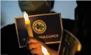  ?? Photograph: Valérie Macon/AFP/ Getty Images ?? A nurse from the Kaiser Permanente Woodland Hills medical center in California holds an electric candle during a candleligh­t vigil in memory of those lost during the pandemic.