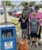  ?? CONTRIBUTE­D ?? A family provides donations at the Jamestown Community Library Little Pantry unveiling.