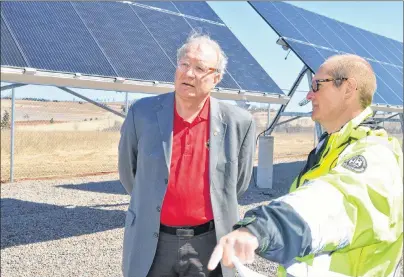  ?? DAVE STEWART/THE GUARDIAN ?? Richard MacEwen, right, manager of Charlottet­own’s Water and Sewer Utility, goes over one of the big features of Charlottet­own’s new wellfield, the 100-kilowatt solar photovolta­ic installati­on, with Premier Wade MacLauchla­n. The site was officially...