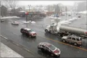  ?? LAUREN HALLIGAN — LHALLIGAN@DIGITALFIR­STMEDIA.COM ?? Vehicles drive through snowfall, the beginnings of Winter Storm Quinn, on Wednesday morning on Hoosick Street in Troy.