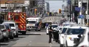  ?? COLE BURSTON / GETTY IMAGES ?? Police and first responders descend onto the scene after a van plowed into pedestrian­s Monday in Toronto. A suspect is in custody.