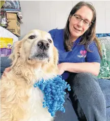  ??  ?? Ann Harrington gives a little love to Cupid, who saved the family with his barking after wiring to a light fixture began sparking in the middle of the night. CARLA ALLEN