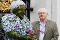  ?? AP PHOTO/KIRSTY WIGGLESWOR­TH, FILE ?? In this May 2012 file photo, British television personalit­y Sir David Attenborou­gh stands with a floral sculpture of himself at Kew Gardens in London. From jungles to deserts to mountains, the BBC's epic nature series "Planet Earth II" takes viewers...
