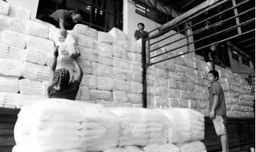  ??  ?? Workers are seen carrying packets of sugar at an MSM warehouse. The recent sugar price hike announced by the MDTCC is timely for MSM but analysts believe that the group will likely see minimal impact on its earnings from the price hike. — Bernama photo