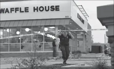  ?? Associated Press photo ?? Law enforcemen­t officials work the scene of a fatal shooting at a Waffle House in the Antioch neighborho­od of Nashville, Sunday.