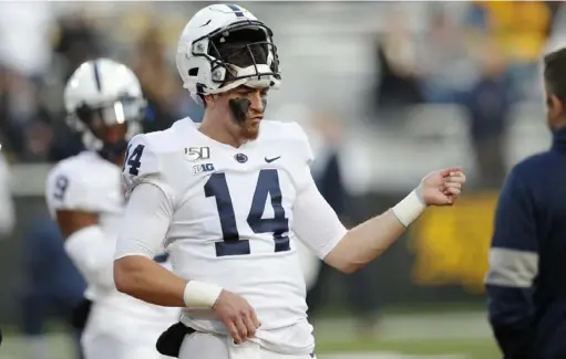  ?? AP ?? Penn State quarterbac­k Sean Clifford, playing the air guitar, above, during warm-ups for last weekend’s Iowa game, has directed the Nittany Lions to a 6-0 start and a No. 7 ranking in the Associated Press and coaches’ top 25.