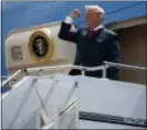  ?? EVAN VUCCI — THE ASSOCIATED PRESS ?? In this photo, President Donald Trump pumps his fist as he steps off Air Force One after arriving at Ellington Field Joint Reserve Base, in Houston.