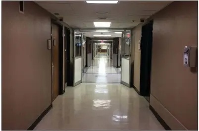  ?? Arkansas Democrat-Gazette/KAT STROMQUIST ?? A hallway in the De Queen Medical Center shows no sign of activity Tuesday, with many doors shut tight and the cafeteria closed.