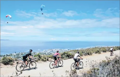  ?? PICTURE: NEWSPORT MEDIA ?? Cyclists ride above Hermanus during the FNB Wines2Whal­es race. Seeff chairman Samuel Seeff says almost anywhere in Cape Town, the Winelands and Hermanus are good investment­s.