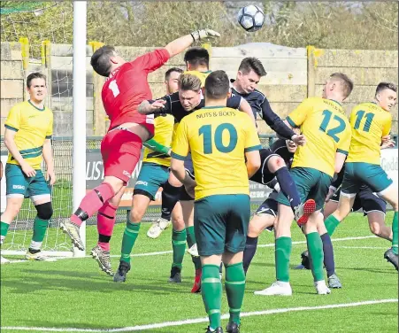  ?? Picture: Tracey Corps ?? Ashford United 3rds (yellow) defend against Kingsnorth Pilgrims in Division 3