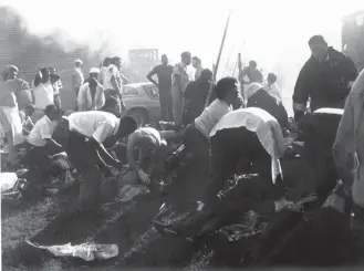  ?? RICHMOND COUNTY DAILY JOURNAL ?? Rescue workers help victims outside Imperial Food Products in Hamlet, N.C., in 1991 after a fire at the chicken-processing plant left at least 25 people dead and more than 54 injured.