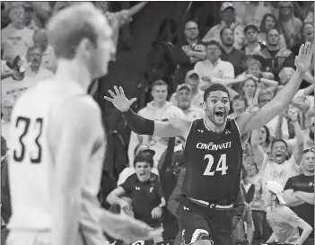  ?? TRAVIS HEYING/THE WICHITA EAGLE/AP PHOTO ?? Cincinnati’s Kyle Washington celebrates after Wichita State’s Conner Frankamp (33) missed a 3-pointer that would have won Sunday’s American Athletic Conference game in Wichita, Kan. Cincinnati won, 62-61.