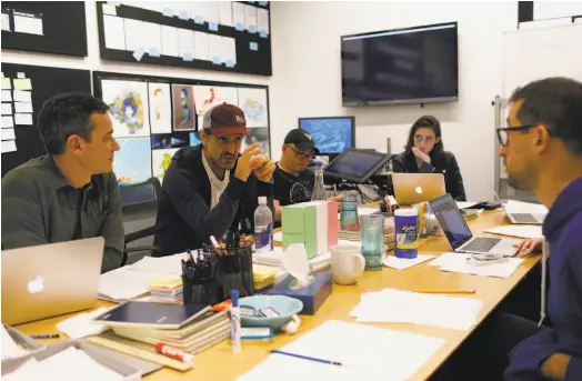  ?? Deborah Coleman / Pixar 2019 ?? “Luca” director Enrico Casarosa (second from left) meets with writer Mike Jones (left), story supervisor John Hoffman, story coordinato­r Mattie Brehm and writer Jesse Andrews at Pixar Animation Studios in Emeryville in July 2019.