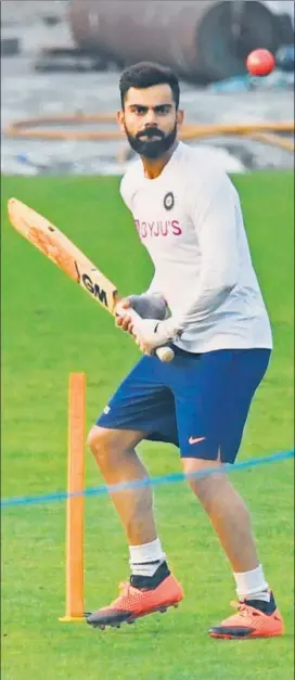  ??  ?? India skipper Virat Kohli takes throw-downs of the pink ball after a game of football during India’s training session at Eden Gardens on Wednesday.
AFP