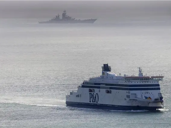  ??  ?? A Russian Naval vessel passes a ferry in the English Channel yesterday (Getty)