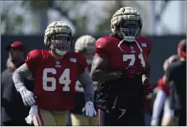  ?? JEFF CHIU — THE ASSOCIATED PRESS FILE ?? San Francisco 49ers center Jake Brendel (64) and offensive tackle Trent Williams (71) take part in drills at the team’s practice facility in Santa Clara on Friday, Aug. 5.