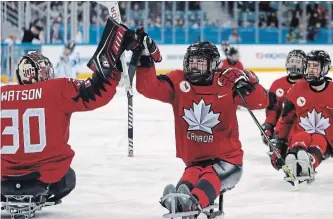  ?? NG HAN GUAN THE ASSOCIATED PRESS ?? Canada's Billy Bridges, centre, celebrates a goal with goalkeeper Corbin Watson during a semifinal match against South Korea in the 2018 Winter Paralympic­s at the Gangneung Hockey Centre on Thursday.