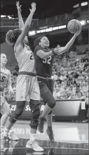  ?? AP/L.G. PATTERSON ?? South Carolina’s Tyasha Harris (52) shoots past Missouri’s Cierra Porter (21) in the second half of the Tigers’ 83-74 victory over the Gamecocks on Sunday in Columbia, Mo.