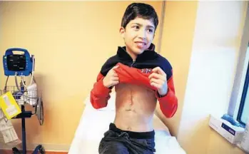  ?? CARLINE JEAN/STAFF PHOTOGRAPH­ER ?? On his 14th birthday, Estefano Reano, ofWeston, wished for a new heart. Just 30 minutes later he received word that a heart had been found. Since the surgery, Estefano has gained 15 pounds and grown 2 inches.