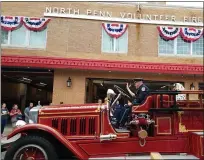  ?? DAN SOKIL — MEDIANEWS GROUP ?? North Penn Volunteer Fire Company members ride “Bertha,” a vintage 1929fire engine, past the fire company’s station in the North Wales 150th anniversar­y parade in September 2019.