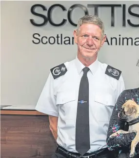  ??  ?? At the Scottish SPCA’s office in Dunfermlin­e are, from left, Chief Superinten­dent Mike Flynn, Rural Affairs Minister Mairi Gougeon and chief executive Kirsteen Campbell, along with Bella the pug, who started life with an unlicensed dealer but has been rehomed.