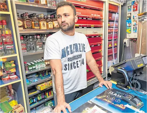  ??  ?? Arsalan Haider behind the counter at Court Street News.