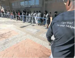  ?? / ESA ALEXANDER ?? A SARS employee assists clients at the revenue service offices on Long Street, Cape Town.