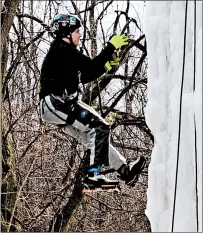  ??  ?? Joel Taylor demonstrat­es how to climb ice at his home-built tower.