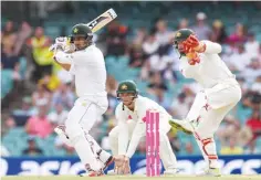  ??  ?? SYDNEY: Pakistan batsman Sharjeel Khan (left) cuts a ball away as Australia’s Matthew Wade (right) and Peter Handscomb look on on the fourth day of the third cricket Test match against Australia at the SCG yesterday. —AFP