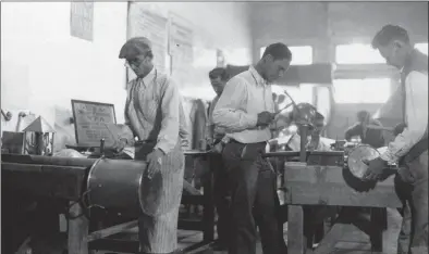  ?? Associated Press file photo ?? In this March 26, 1937, photo, Works Progress Administra­tion (WPA) workers make copper utensils for Pima County Hospital in Texas. The New Deal was a try-anything moment during the Great Depression that remade the role of the federal government in American life.