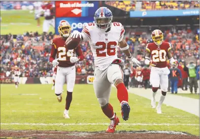  ?? Patrick Smith / Getty Images ?? Saquon Barkley rushes for a 78-yard touchdown in the second quarter against the Redskins Sunday in Landover, Md.