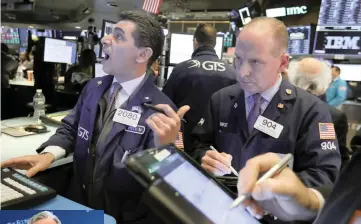  ?? | AP ?? TRADERS at the New York Stock Exchange. Instead of the traditiona­l Christmas rally, US equities slumped in December and dragged other major markets down. It turned out to be the worst December for the S&amp;P500 since the 1930s, with a 9 percent decline.