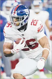  ?? JOE ROBBINS/GETTY ?? If Saquon Barkley stays on his rookie pace, his production over the next few years could be proof enough for the Giants to offer him a larger contract extension when the time comes.