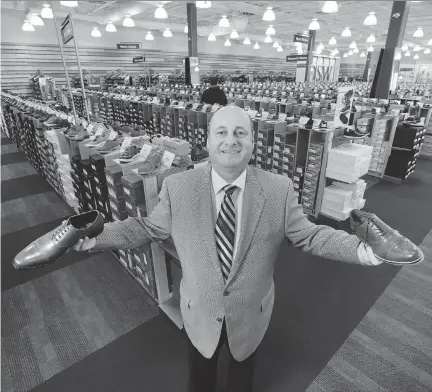  ?? PETER J. THOMPSON/NATIONAL POST FILES ?? Town Shoes CEO Bruce Dinan visits a DSW store, which is now dwarfed by the company’s online selection.