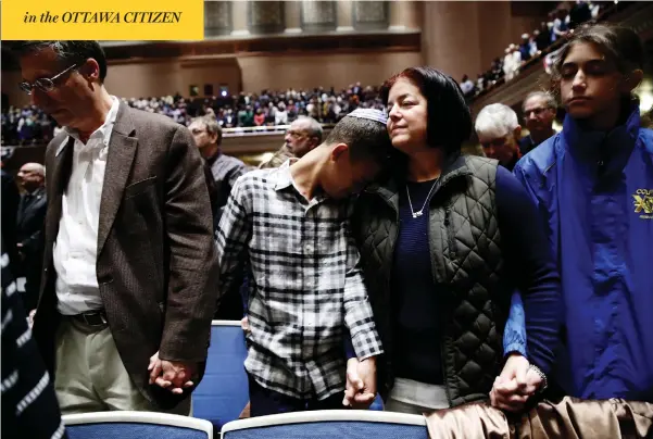  ?? MATT ROURKE / THE ASSOCIATED PRESS ?? People mourn in Soldiers and Sailors Memorial Hall and Museum in Pittsburgh on Sunday during a community gathering in the aftermath of Saturday’s mass shooting at the city’s Tree of Life Synagogue. Eight men and three women were killed when a gunman opened fire on worshipper­s.