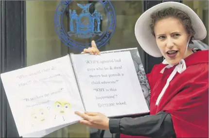  ?? Photos by Paul Buckowski / Times Union ?? A woman dressed in a costume from “The Handmaid’s Tale” takes part in a protest outside Tuesday’s JCOPE meeting in Albany. The protest concerned the panel’s pursuit of Child Victims Act advocate Kat Sullivan.