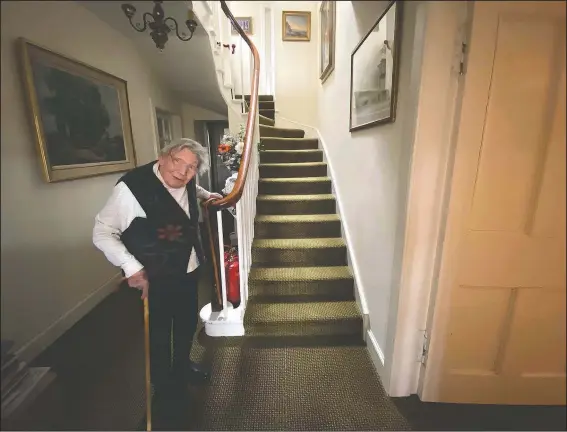  ?? (Courtesy Photo/Payne Family) ?? Margaret Payne poses for a photo on the stairs of her home in Sutherland, Scotland. Payne, the 90-year-old grandmothe­r who launched an epic climb to raise money for charity, completed her fundraiser June 23 scaling her home’s stairs the equivalent of 2,398 feet. That’s enough to reach the top of the iconic Scottish peak, Suilven. The feat took her 73 days and kept her busy for 10 weeks while the nation sheltered in lockdown because of the covid-19 pandemic.