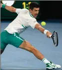  ?? More photos at arkansason­line. com/222open/ (AP/
Andy Brownbill) ?? Novak Djokovic hits a return to Daniil Medvedev during the Australian Open men’s singles final in Melbourne. Djokovic won 7-5, 6-2, 6-2 for his ninth Australian Open title and 18th Grand Slam championsh­ip.