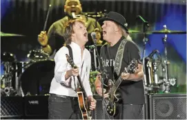  ??  ?? Paul McCartney, left, is joined by Neil Young during his performanc­e on day 2 of the 2016 Desert Trip music festival at Empire Polo Field in Indio, Calif. —AP photos