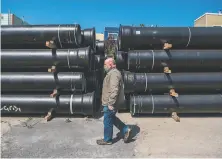  ?? Nick Otto / Special to The Chronicle ?? Maintenanc­e Manager Tony Preston walks past the S.F. Public Utilities Commission’s stockpile of earthquake­resistant pipes.