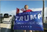  ?? GREG LOVETT/PALM BEACH POST VIA AP ?? Mary Jude Smith cheers for President Donald Trump as his motorcade passes by on Southern Blvd. enroute to his Mara-Lago estate from Trump Internatio­nal Golf Club, Dec. 28, in West Palm Beach, Fla.