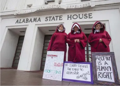  ?? Photograph: Mickey Welsh/AP ?? Women protest the anti-abortion bill in front of the Alabama State House on 17 April. Alabama recently passed a law making providing an abortion a felony.