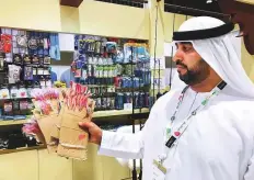  ?? Binsal Abdul Kader/Gulf News ?? Omar Al Muhairbi shows off fishing equipment at his stall at Adihex in the capital yesterday.