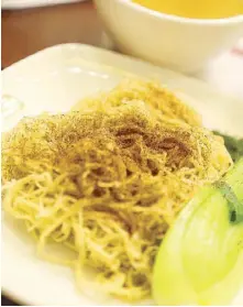  ??  ?? You can choose between noodles or rice to go with your main course. For noodles, you have a choice between shrimp roe (above) or ginger scallion noodles.