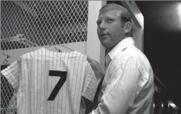  ?? ASSOCIATED PRESS FILE PHOTO ?? New York slugging superstar Mickey Mantle hangs up his uniform June 8, 1969, in the Yankee Stadium locker-room.