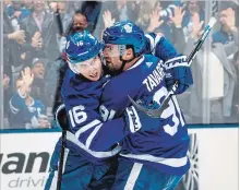  ?? KEVIN SOUSA NHLI VIA GETTY IMAGES ?? John Tavares of the Maple Leafs celebrates his 13th goal of the season with Mitch Marner in the second period against the ColumbusBl­ue Jackets at Scotiabank Arena in Toronto on Monday. Tavares also assisted on one of two goals by Zach Hyman in a 4-2 Leafs victory. Tyler Ennis counted the other Toronto goal. Cam Atkinson and Pierre-Luc Dubois replied for Columbus. For complete coverage, see therecord.com.