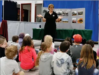  ?? ?? Carol Masecar of Val Marie speaks with Grade 1 students from All Saints Catholic School during her presentati­on about the story of a beef burger from pasture to plate, April 28.