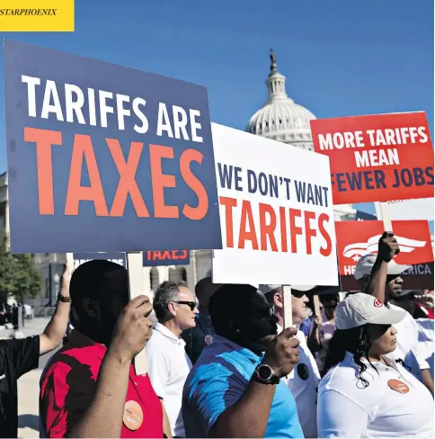  ?? ANDREW HARRER/BLOOMBERG ?? Autoworker­s show their displeasur­e with a U.S. proposal to put tariffs on autos at a news conference on Capitol Hill in Washington Thursday. Canadian officials told U.S. lawmakers during a day of hearings that Canada is not a national security threat...