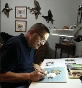  ?? BEN HASTY — MEDIANEWS GROUP ?? Artist Scott Calpino works in his Penn Township studio. He has had a number of his paintings featured on duck stamps.