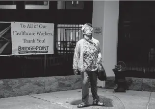  ?? Amanda Andrade-Rhoades / Washington Post contributo­r ?? LaToya Francis stands outside a Bridgepoin­t Healthcare facility in Washington, D.C., where she makes little more than minimum wage and increasing­ly is the only one on the overnight shift.